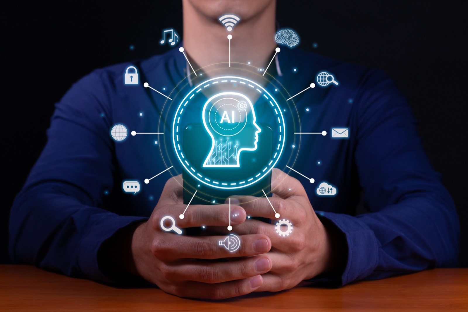 AI and automation icons projected above a smartphone held in a person's hands.